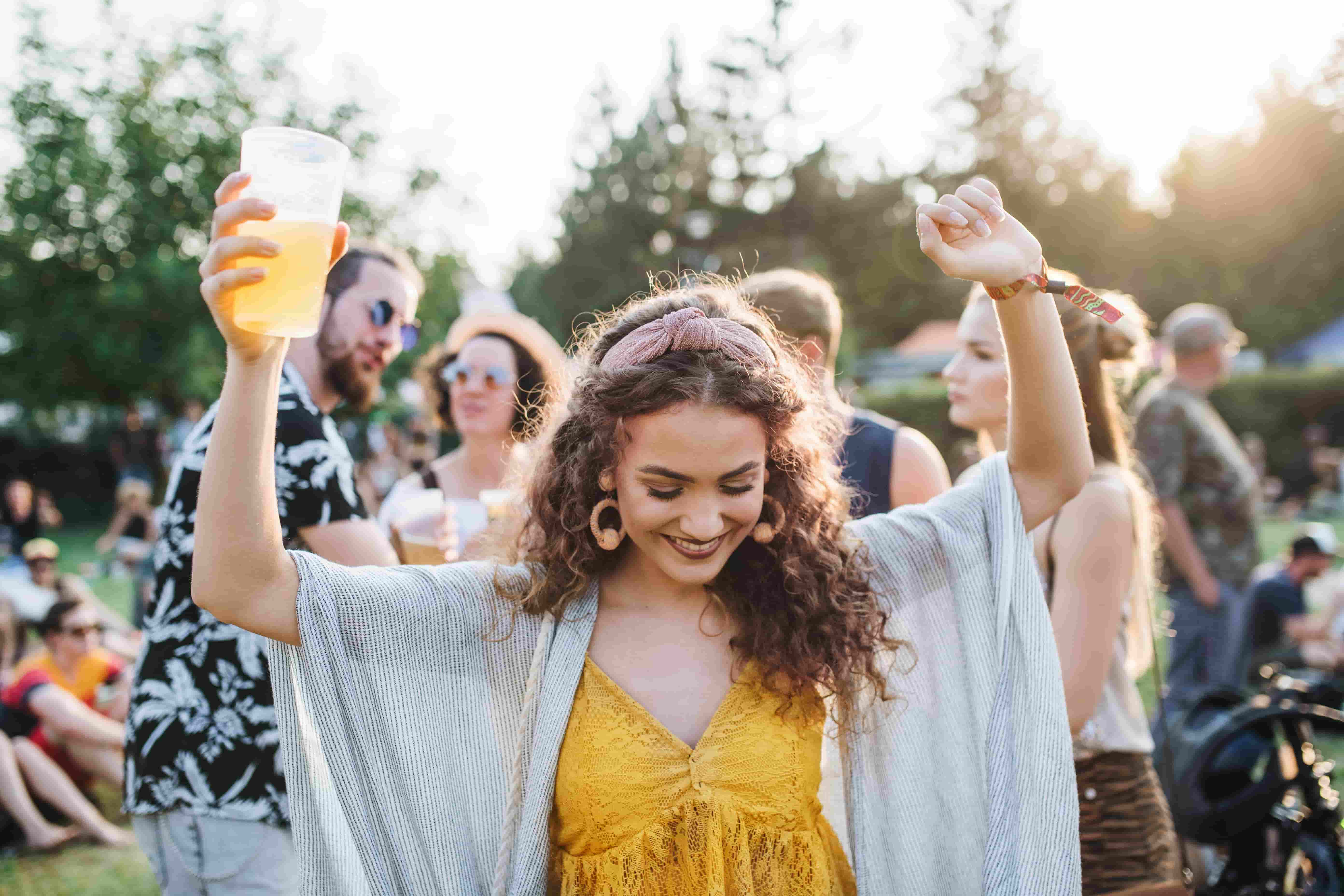 a-young-woman-with-drink-dancing-at-summer-festiva-2023-11-27-05-18-57-utc (1)